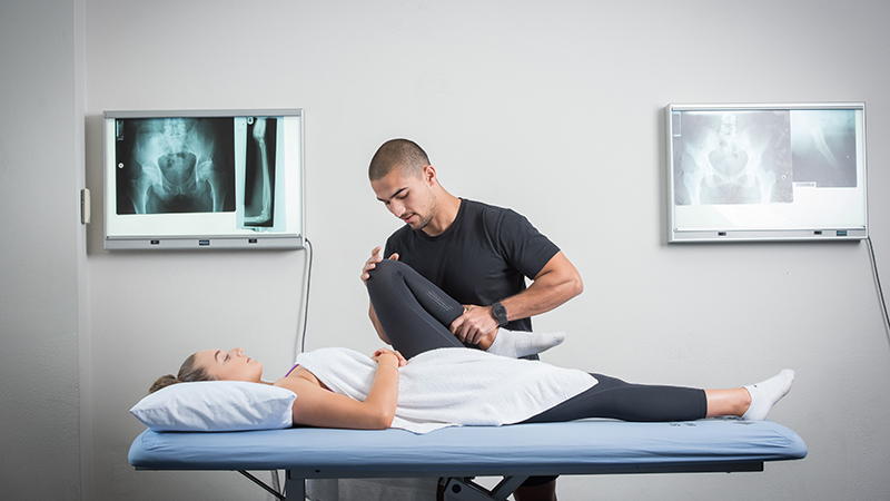 A physiotherapy student completes practical training.