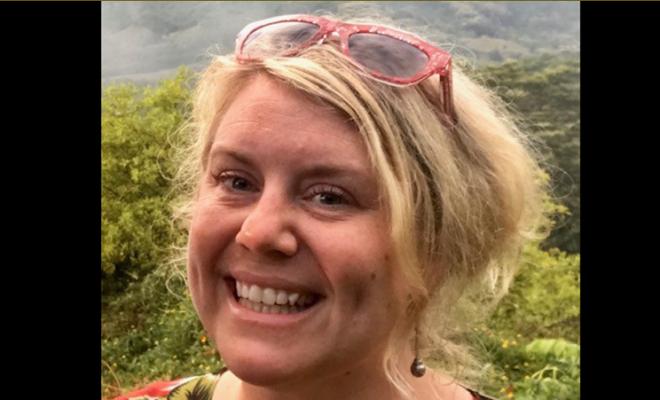 Shelly Hewson-Munro, smiling portrait in front of Australian forest