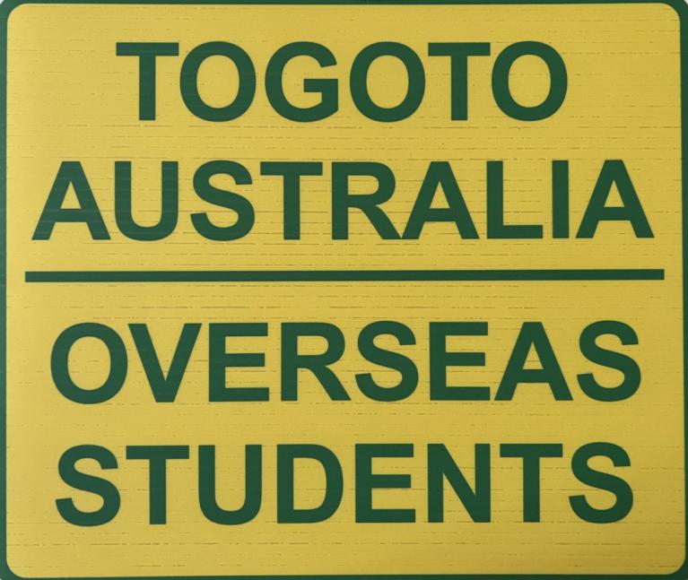  A yellow sign with the words "TOGOTO Australia | Overseas Students" written on it.