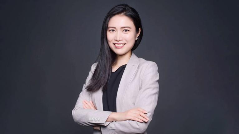 Catherine Lou, young female researcher, in professional clothing smiling at camera