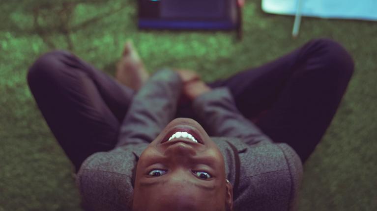  girl smiling in front of laptop