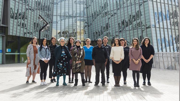 Group of learning hub advisors pose in outside the VU library