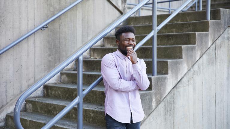  Man standing in front of concrete stairs, outdoors.