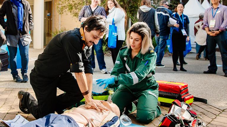 Paramedic students practising their skills on a mannequin.