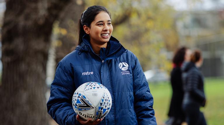  VU sports student outside with a soccer ball.