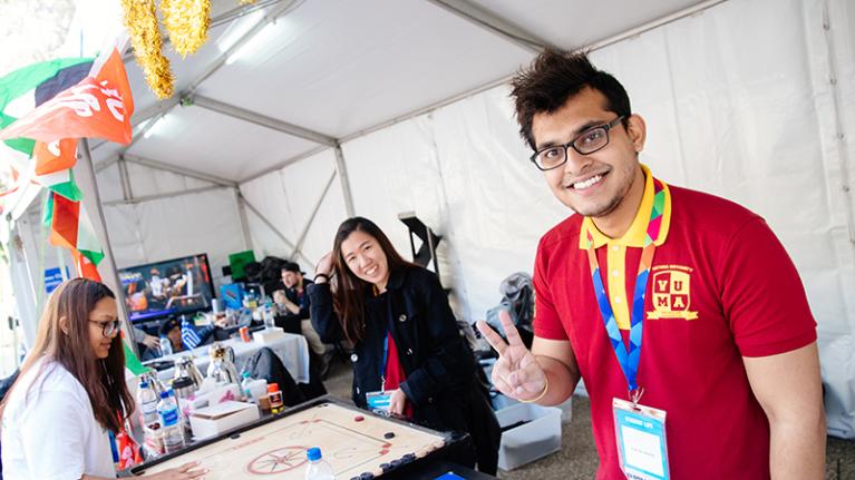 Malaysian student and female student promoting cultural and games clubs at orientation