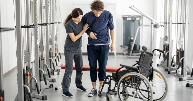  An allied health worker assisting a patient with their rehabilitation.