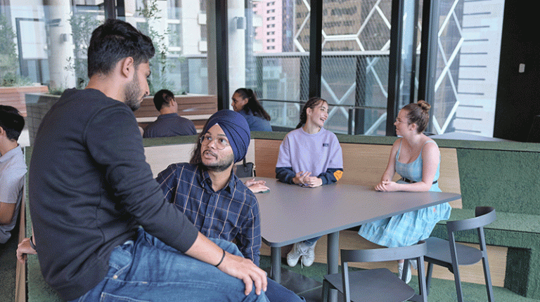  Students sitting around in the City Campus student lounge