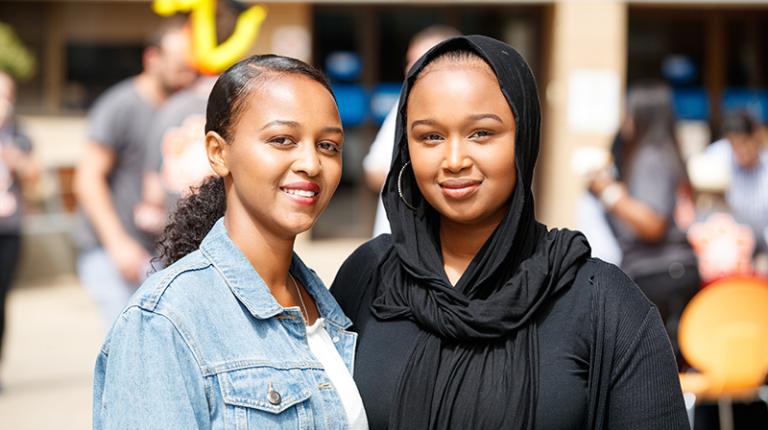 Two smiling women of colour. 