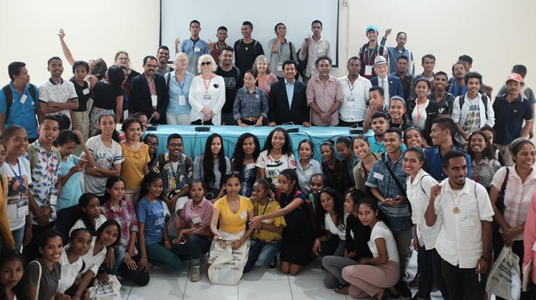 A huge group of smiling, enthusiastic majority East Timorese people at a conference