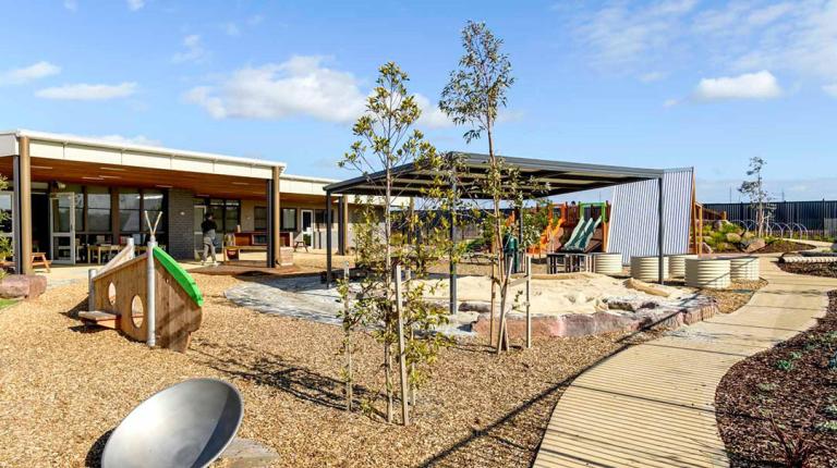 A new community space with playground equipment and modern building