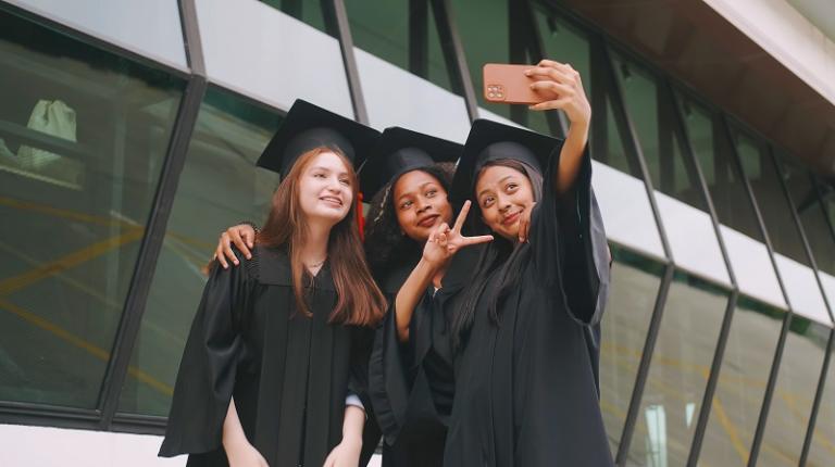  Three female graduates posing together for an informal selfie