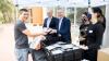  VU student Luciano Freire picks up free food packs from VC Adam Shoemaker and Deputy VC (People and Organisation) Peter Radoll, accompanied by VU students Shiva Foroutan and Ashlie Thorburn