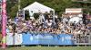 AFL crowd behind a Victoria University logo barrier