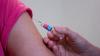 Person receiving a vaccine in their arm