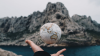 Ball representing earth in hand