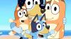Four colourful cartoon dogs at the beach