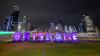 Illuminated 'Brisbane' sign at night.