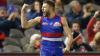 Bulldogs player raises a victory fist on the field