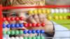 A child plays with an abacus.