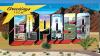 A colourful sign saying Greetings from El Paso, with mountains in the background and blue sky