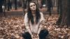  Girl sitting on ground in leaves