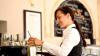 Female cafe worker making coffee