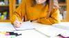  A year 7 student student in a yellow jumper does homework.