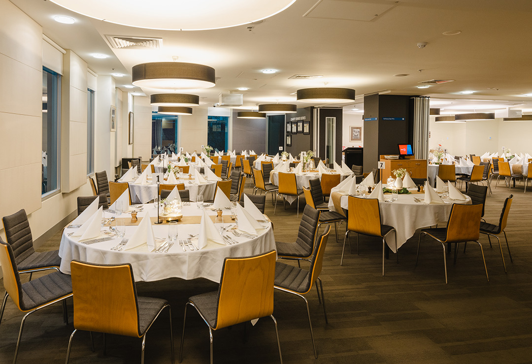 A room with beautifully set tables