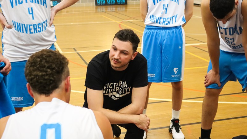  Coach Maverick Clissold talks to his players on the court